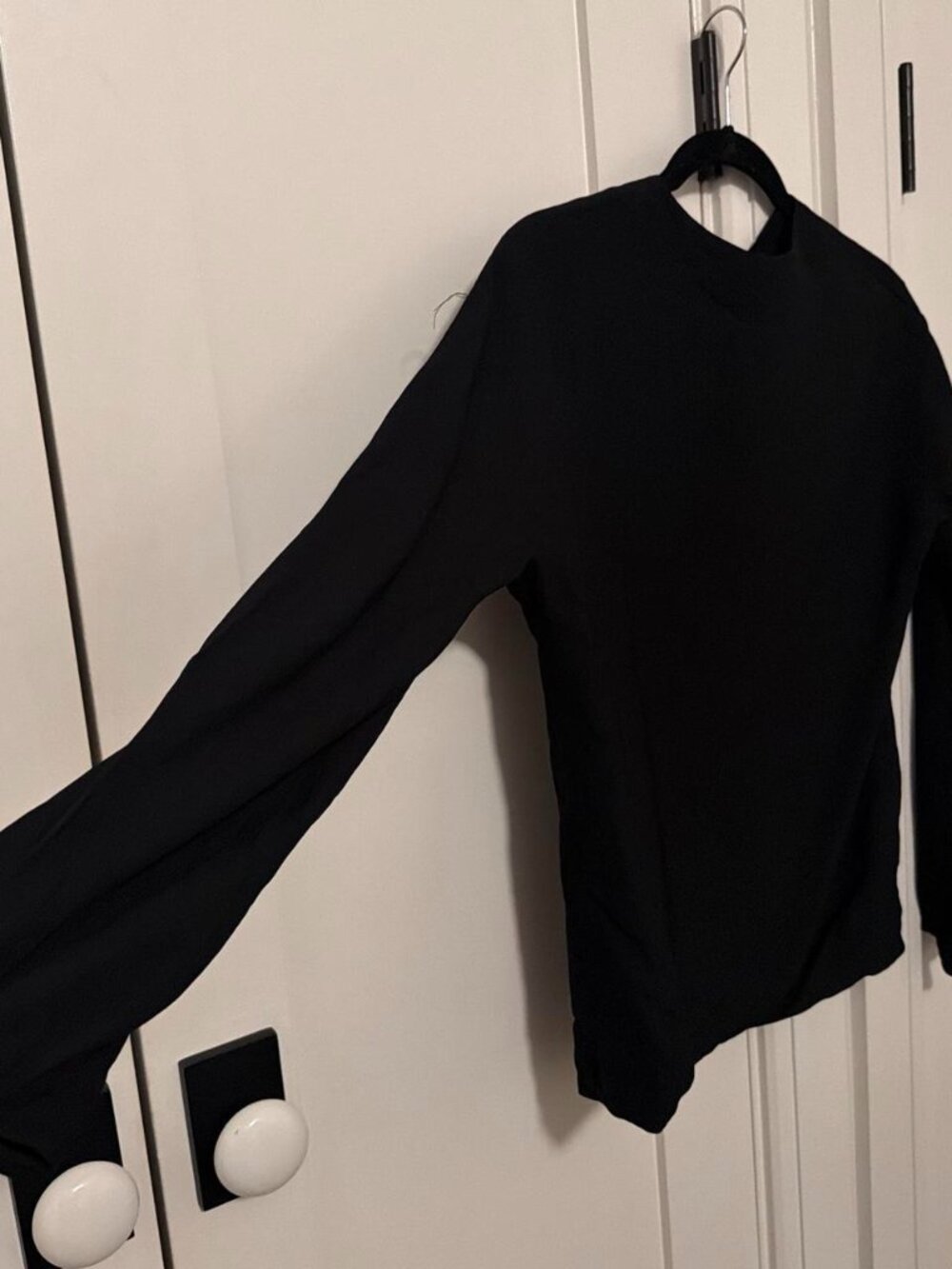 Black long sleeve top with open back and tie
